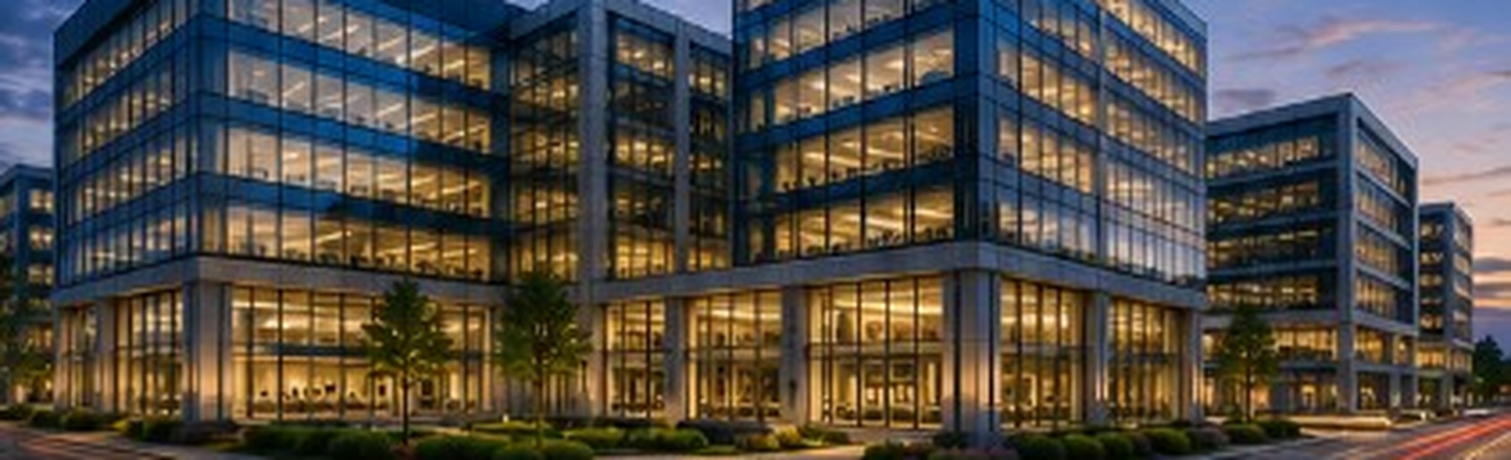 Modern glass office building at dusk